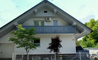 a house with a balcony on top of it at Sunset Bled in Bled