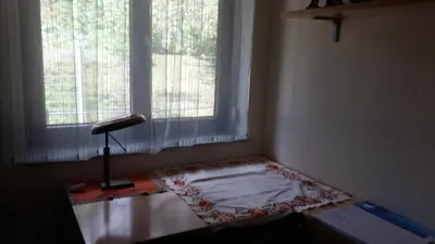 a room with a table in front of a window at ANERI in Ljubljana