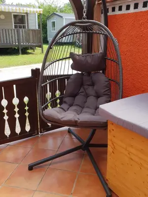 a chair with a pillow on a porch at Aparthouse SUPREME with Terme Catez Swimming Pools Tickets in Čatež ob Savi