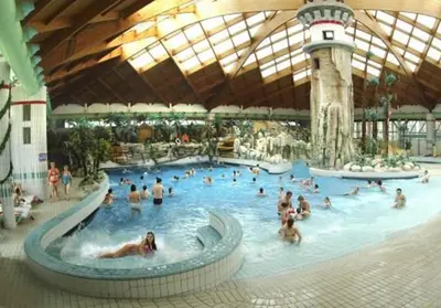 a group of people in a large swimming pool at Aparthouse SUPREME with Terme Catez Swimming Pools Tickets in Čatež ob Savi