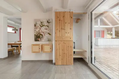 a room with a wooden door and a table at Garden living in Bled