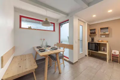 a kitchen and dining room with a table and chairs at Garden living in Bled