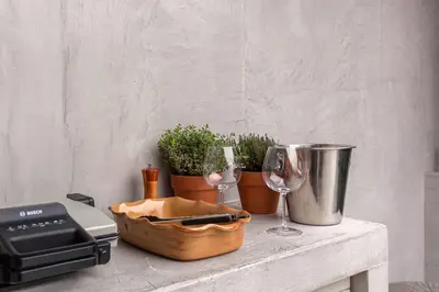 a table with two wine glasses and a toaster at Garden living in Bled