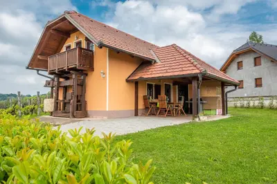 a house with a porch and a balcony at Wineyard getaway house in Sevnica
