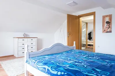 a bedroom with a bed and a dresser and a mirror at Wineyard getaway house in Sevnica
