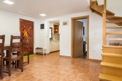 a living room with a staircase and a table at Wineyard getaway house in Sevnica