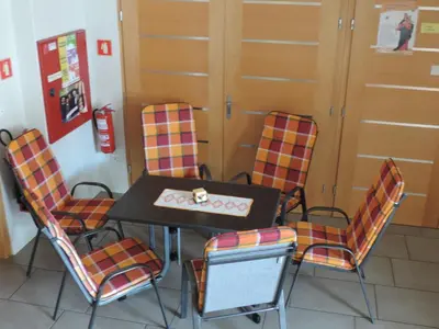 a table and four chairs in a room at Marijin dom - Retreat House in Bled