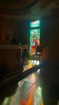 a room with a stained glass window and a chair at Marijin dom - Retreat House in Bled