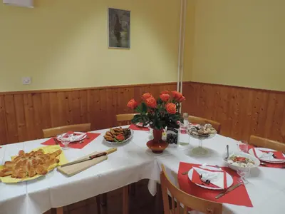a table with food and flowers on top of it at Marijin dom - Retreat House in Bled