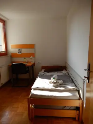 a bed in a small room with a bed frame at Marijin dom - Retreat House in Bled