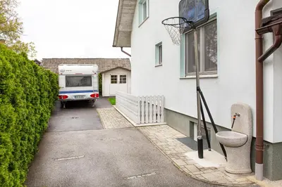 a truck parked next to a house with a basketball hoop at Orchid room for 2, Skylight room for 2 in Kranj