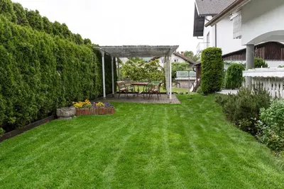a yard with a green lawn with a table and chairs at Orchid room for 2, Skylight room for 2 in Kranj