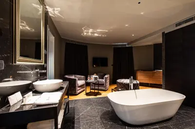 a bathroom with two sinks and a bath tub at DAM boutique hotel & restaurant in Nova Gorica