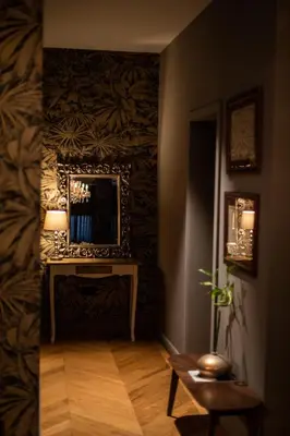 a hallway with a table and a mirror on a wall at DAM boutique hotel & restaurant in Nova Gorica