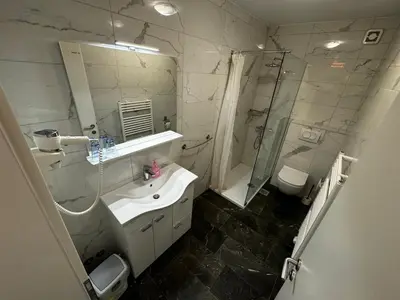 a bathroom with a sink and a shower and a toilet at Gostišče pri Slavcu in Šentjernej