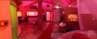 a room with pink and green lights on the walls at SECRET WELLNESS in Bodonci