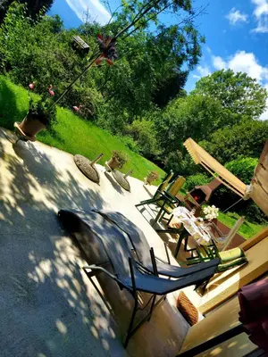 a couple of lawn chairs sitting on a patio at Alpinejka House in Tržič