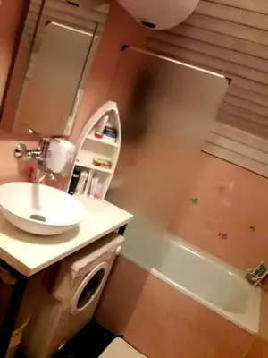 a bathroom with a sink and a mirror and a tub at Alpinejka House in Tržič