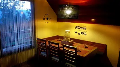 a small dining room with a table and chairs at Alpinejka House in Tržič