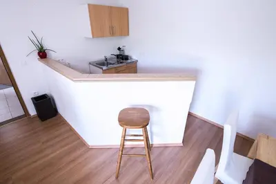 a stool sitting at a counter in a kitchen at Apartmaji Baron in Bled