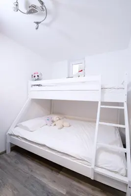 a white bunk bed with a white shelf at Apartmaji Baron in Bled