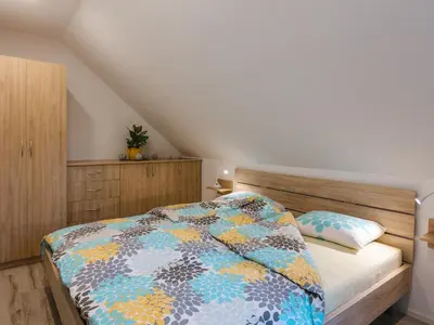 a bedroom with a bed with a colorful quilt at Blue Door in Lesce