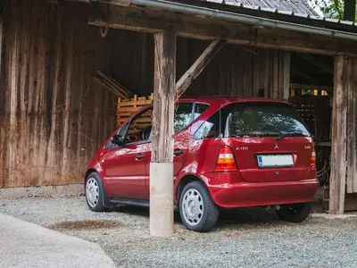 a red car parked in front of a building at Blue Door in Lesce