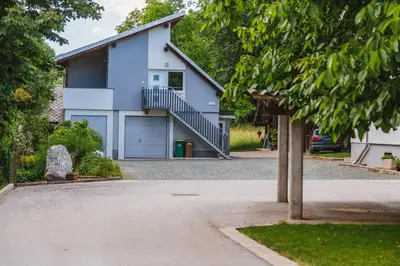 a white house with a garage and a driveway at Blue Door in Lesce