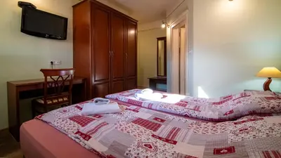 a bedroom with a bed with a quilt on it at VEGANFRESH in Medvode
