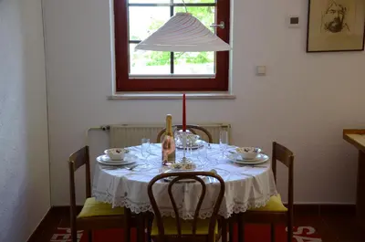 a table with a white table cloth and a lamp at Architect’s house - peaceful and minimalistic in Bled