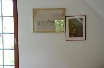 two pictures hanging on a wall next to a window at Architect’s house - peaceful and minimalistic in Bled