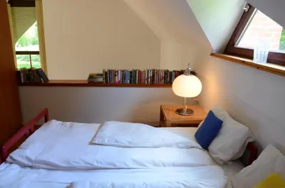 a bedroom with a bed and a lamp and a window at Architect’s house - peaceful and minimalistic in Bled
