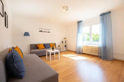 a living room with a couch and a window at Apartment Ksenija in Ljubljana