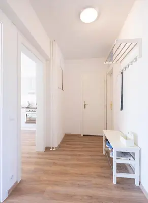 a white room with a staircase and a white table at Apartment Ksenija in Ljubljana
