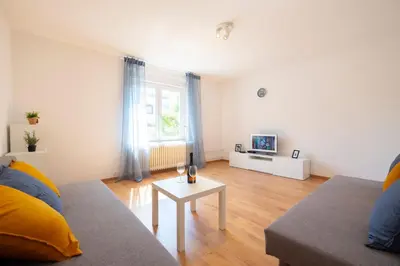 a living room with a couch and a table at Apartment Ksenija in Ljubljana