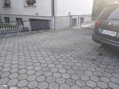 a car parked in a parking lot next to a building at Apartment Ksenija in Ljubljana