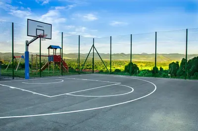 an empty basketball court with a basketball hoop at Camp The sunrise hill in Pivka