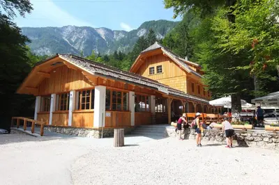 a group of people standing in front of a building at Planinski dom Savica in Bohinj