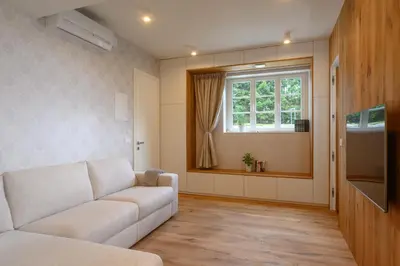 a living room with a couch and a window at Vila Ula La Luxury Apartments in Bled