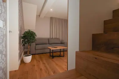 a living room with a couch and a table at Vila Ula La Luxury Apartments in Bled