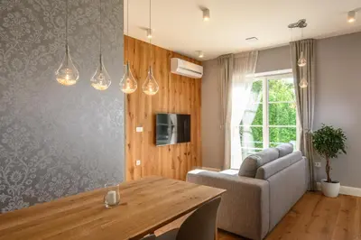 a living room with a table and a couch at Vila Ula La Luxury Apartments in Bled