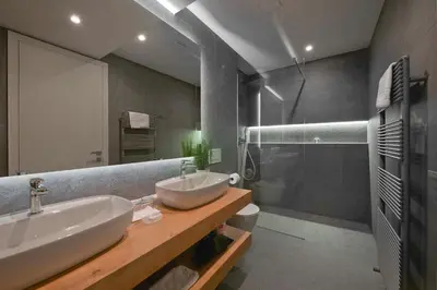 a large bathroom with a sink and a shower at Vila Ula La Luxury Apartments in Bled