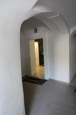 a hallway with a white wall and a doorway at Love Nest apartment in Ljubljana