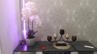 a table with candles and flowers in a room at Love Nest apartment in Ljubljana