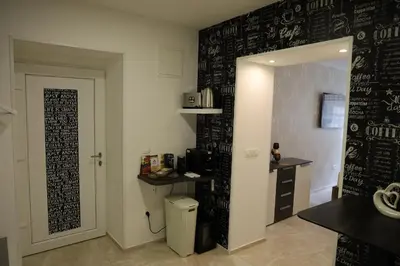 a kitchen with a black wall with writing on it at Love Nest apartment in Ljubljana