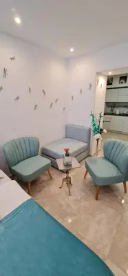 a living room with two blue chairs and a table at Love Nest apartment in Ljubljana