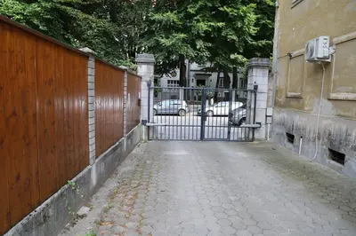 a gate to a driveway in front of a fence at Love Nest apartment in Ljubljana