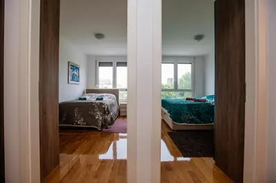 a bedroom with two beds and a window at Bright 2-Bed Apartment Free Parking & WiFi - Walk to Old Town in Ljubljana