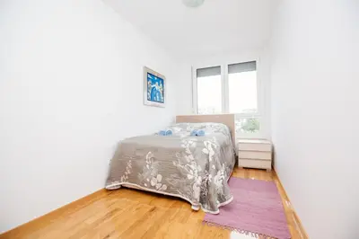 a bedroom with a bed and a window at Bright 2-Bed Apartment Free Parking & WiFi - Walk to Old Town in Ljubljana