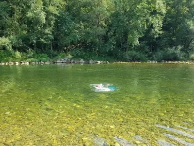 a person swimming in a body of water at Apartma Lahinja in Gradac